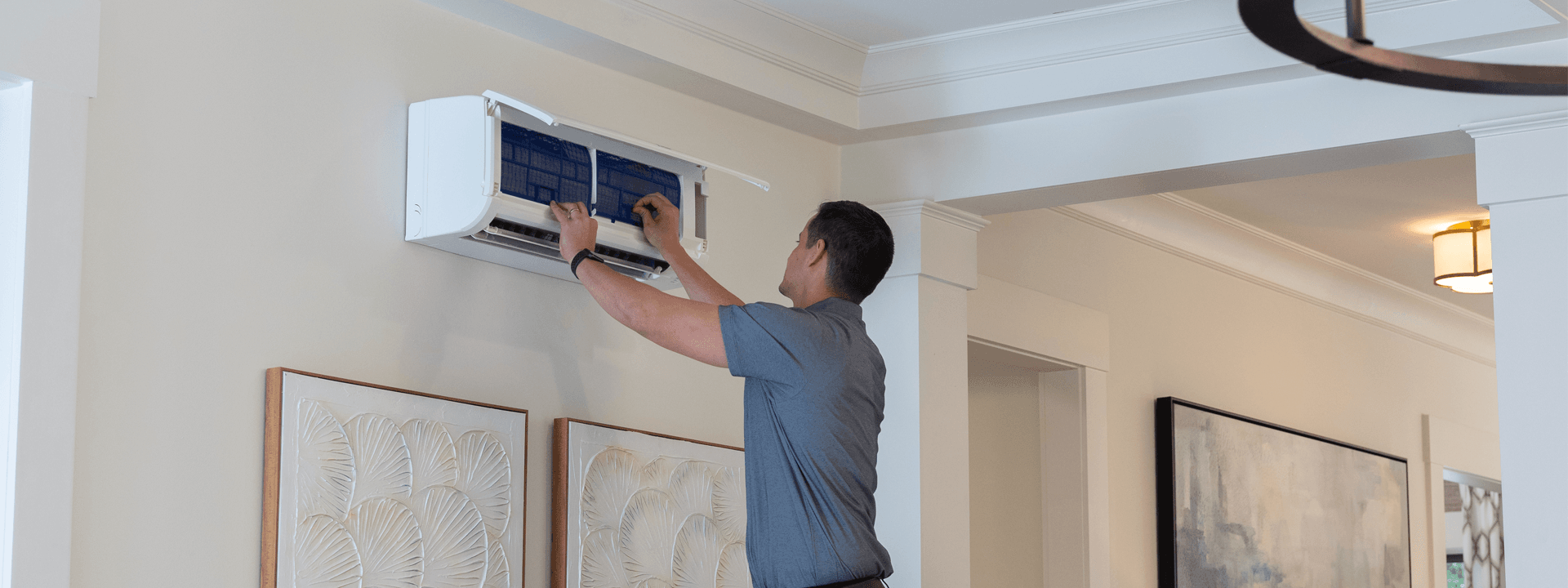 Contractor servicing indoor wall-mounted unit