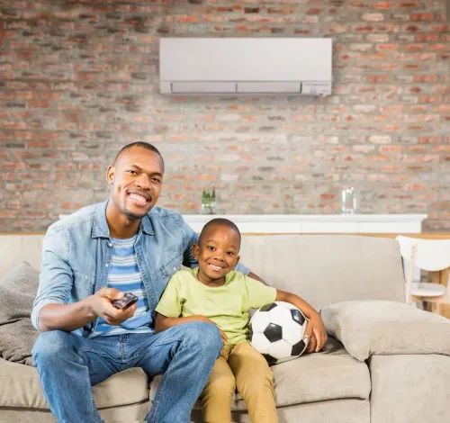 Basement child family sofa sit love togetherness man seat happiness fun casual enjoyment facial expression affection lifestyle woman leisure laughing son