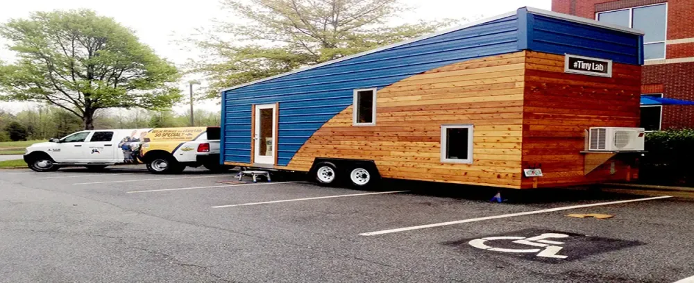 The #TinyLab trailer car wood outdoors truck house vehicle family building architecture door transportation system street caravan road cabin window exterior